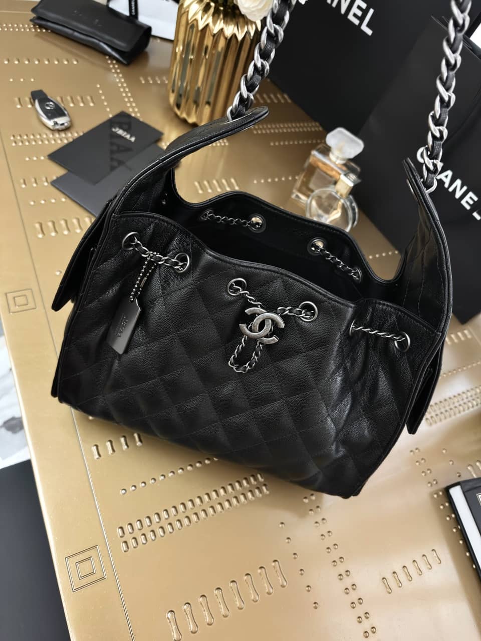 Chanel: 25 bag, black with silver-tone hardware, grained calfskin, 30 × 26 × 14 cm